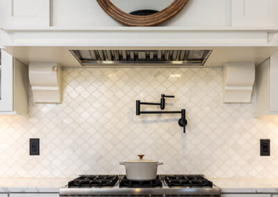 Quartz counter tops with pot filler and marble backsplash